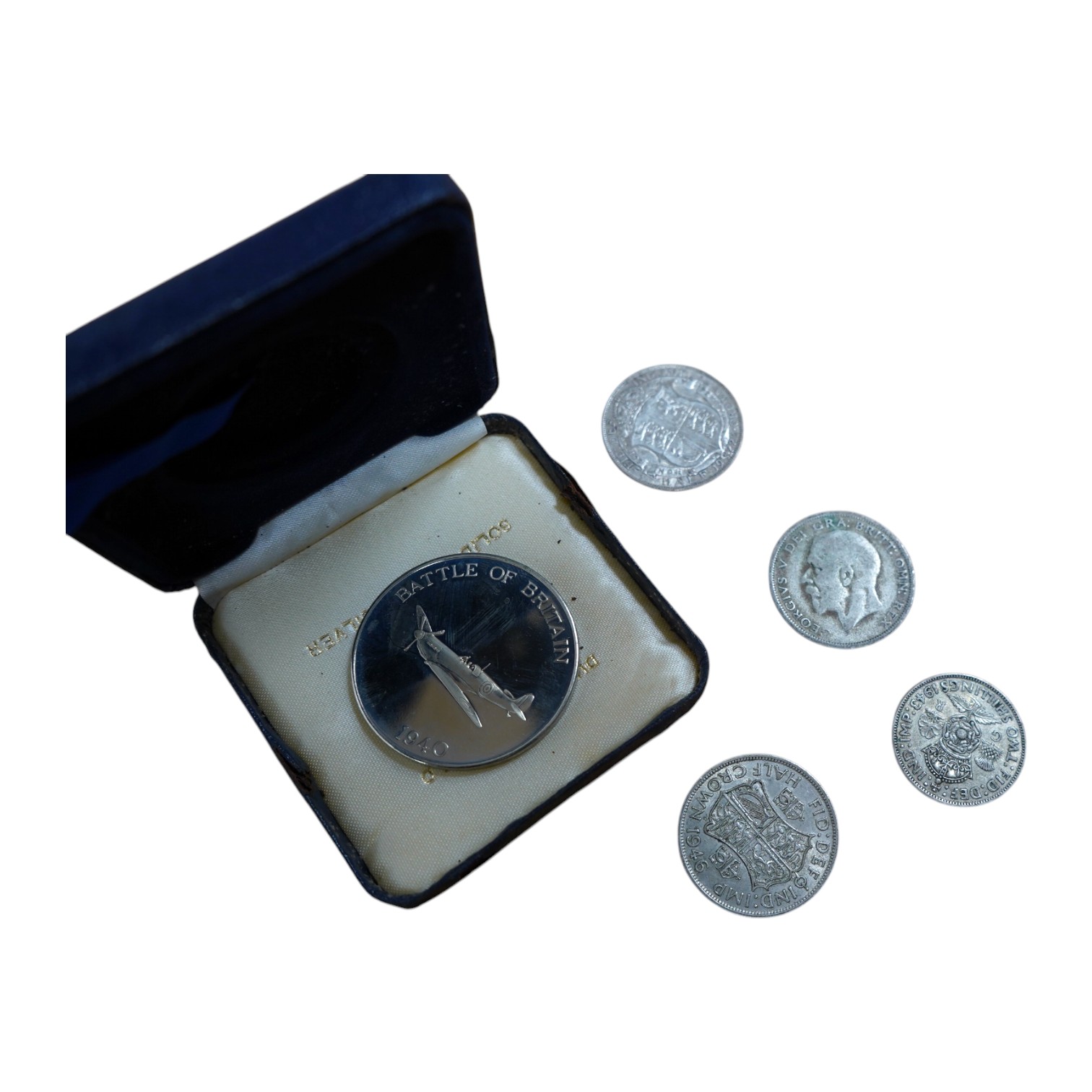 British silver coins, a large quantity of George V and George VI worn half crowns, florins, shillings and sixpences, 1920-1946, together with a Battle of Britain commemorative base metal medal